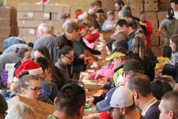 Volunteers help pack boxes of food for the Chatham Goodfellows, December 21, 2016 (Photo by Jake Kislinsky)