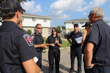 Chatham-Kent firefighters discussing their plans during the post fire reassurance initiative. September 6, 2016. (Photo by Natalia Vega)