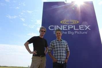 Weather Network Storm Chaser Mark Robinson (left) and Cineplex's Tanner Zipchen pose in front of a giant bag of popcorn set up near Tilbury, August 25, 2016 (Photo by Jake Kislinsky)
