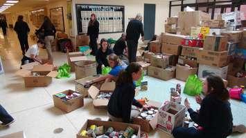 Members of Ursuline College Chatham's "Me to We" group count cans collected during their "Scare Hunger" campaign. (File photo by Jake Kislinsky)