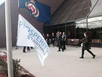Prosperity Round Table members preparing to market Poverty Awareness Week by raising a flag at the Civic Centre Oct. 13, 2015. (Photo by Simon Crouch) 