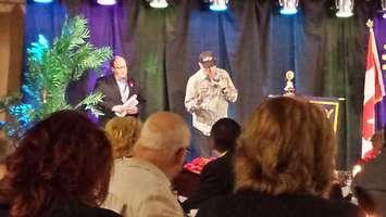Beach Boys co-founder Mike Love (centre) speaks to a crowd at the Rotary Club's 75th banquet in Chatham. November 9, 2014. (Photo courtesy of Walter Ploegman)