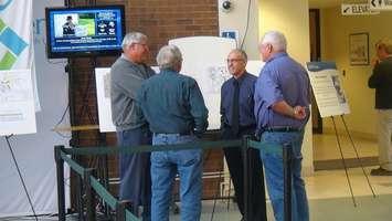 Chatham-Kent Director of Planning Services Ralph Pugliese (centre right) speaks to residents at official plan open house. (Photo by Trevor Thompson).