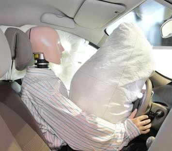 Canstock photo of mannequin and airbag after a crash test
