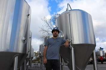 Lead Brewer Colin Chrysler stands with beer-making equipment at the new Sons of Kent location in Downtown Chatham, November 4, 2016 (Photo by Jake Kislinsky)