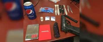 A replica gun, throwing knives and crystal meth was found on a driver and his passenger by police in Chatham. November 29, 2018. (Photo courtesy of Chatham-Kent police)