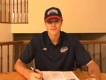 Windsor Spitfires draft pick Kyle McDonald signs his standard OHL contract on June 14, 2018. Photo courtesy Windsor Spitfires.