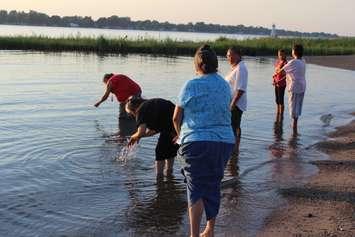 Walpole Island grandmothers praying at the Saint Clair River following the band council's decision to proceed with the Union Gas expansion. August 10, 2016. (Photo by Natalia Vega)