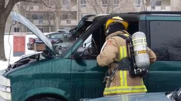 Chatham-Kent Fire crews inspect a toasted vehicle in Chatham (Photo by Jake Kislinsky).