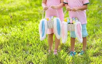 Children collect Easter eggs file photo courtesy of © Can Stock Photo / famveldman
