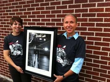 Terry Fox organizing committee members (l to r) Jessica Barton and Lori Timpson hold an auction item that will help raise funds in the fight against cancer. (Photo by Mike James)