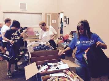 Volunteers at the Chatham-Kent United Way filling 1,200 back packs for students returning to school. August 31, 2015 (Photo by Simon Crouch)