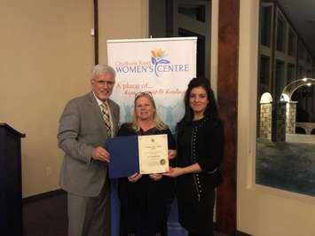 MPP Rick Nicholls presents a certificate to Chatham Kent Women's Centre's Executive Director and Board President. ((Photo courtesy of Chatham Kent Women's Centre Facebook)