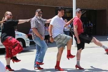 Men dancing at "Walk a Mile in Her Shoes" event. June 3, 2017. (Photo courtesy of Sarah Cowan, Blackburn News Chatham-Kent) 