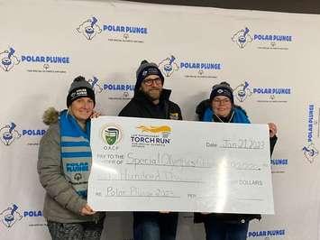 Chatham-Kent police sergeant and polar plunge organizer Jason Herder presents a cheque for $100,000 to Special Olympics Ontario. Photo courtesy of the Torch Run for Special Olympics Facebook Page)