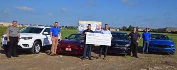 Mike Hogue from Chrysler, Scott Aarssen from Mazda, Adam Lally from Lally
Auto Group, Mike Weber from Lally KIA, and Steve Desjardins from Victory Ford present cheque to Mike
Grail, foundation chair. (Photo courtesy of the Chatham-Kent Children's Treatment Centre Foundation.)